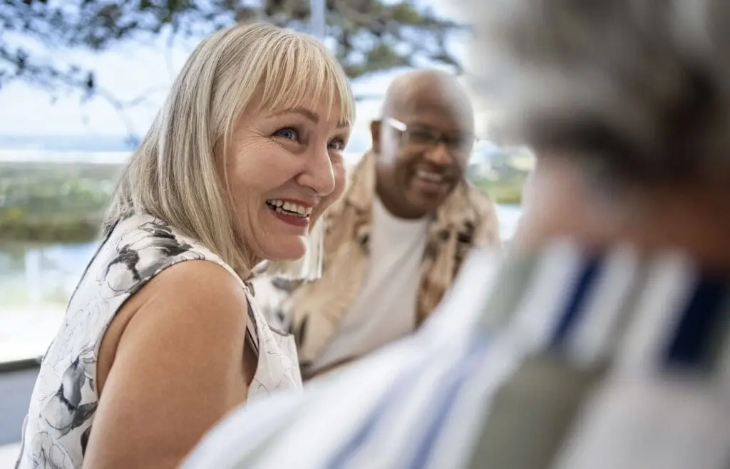 A senior couple downsizing for retirement. They are happy and socializing with other seniors at The Clarendale West End.