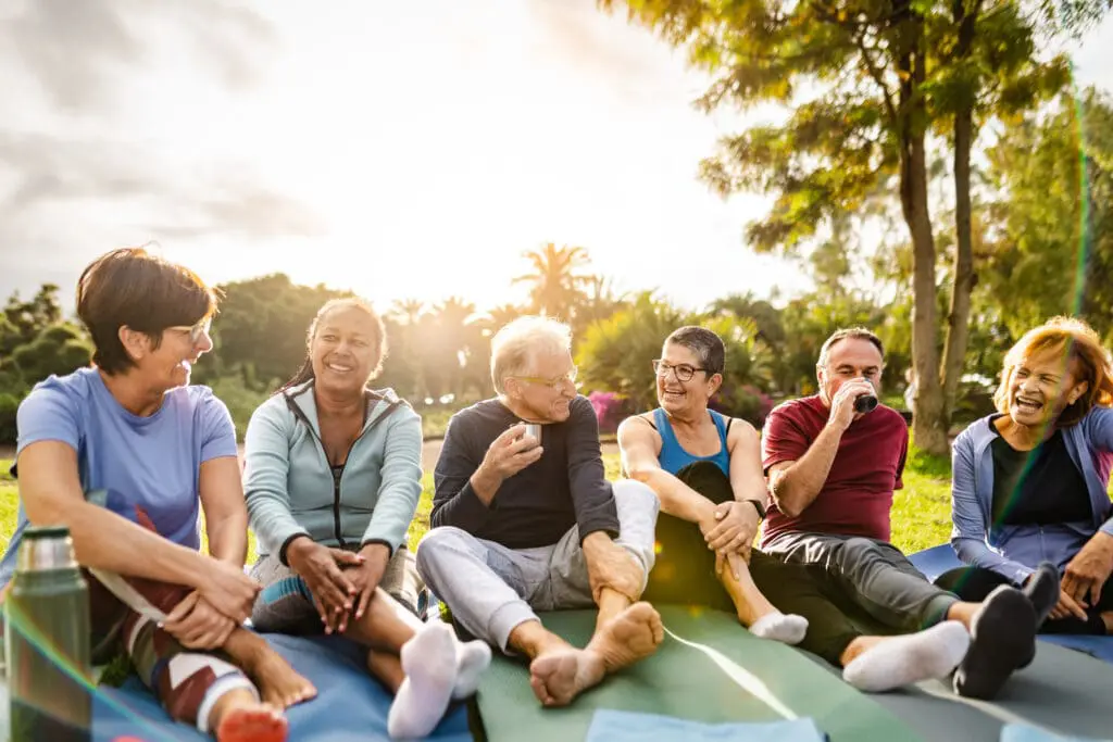 seniors sitting together outside after workout