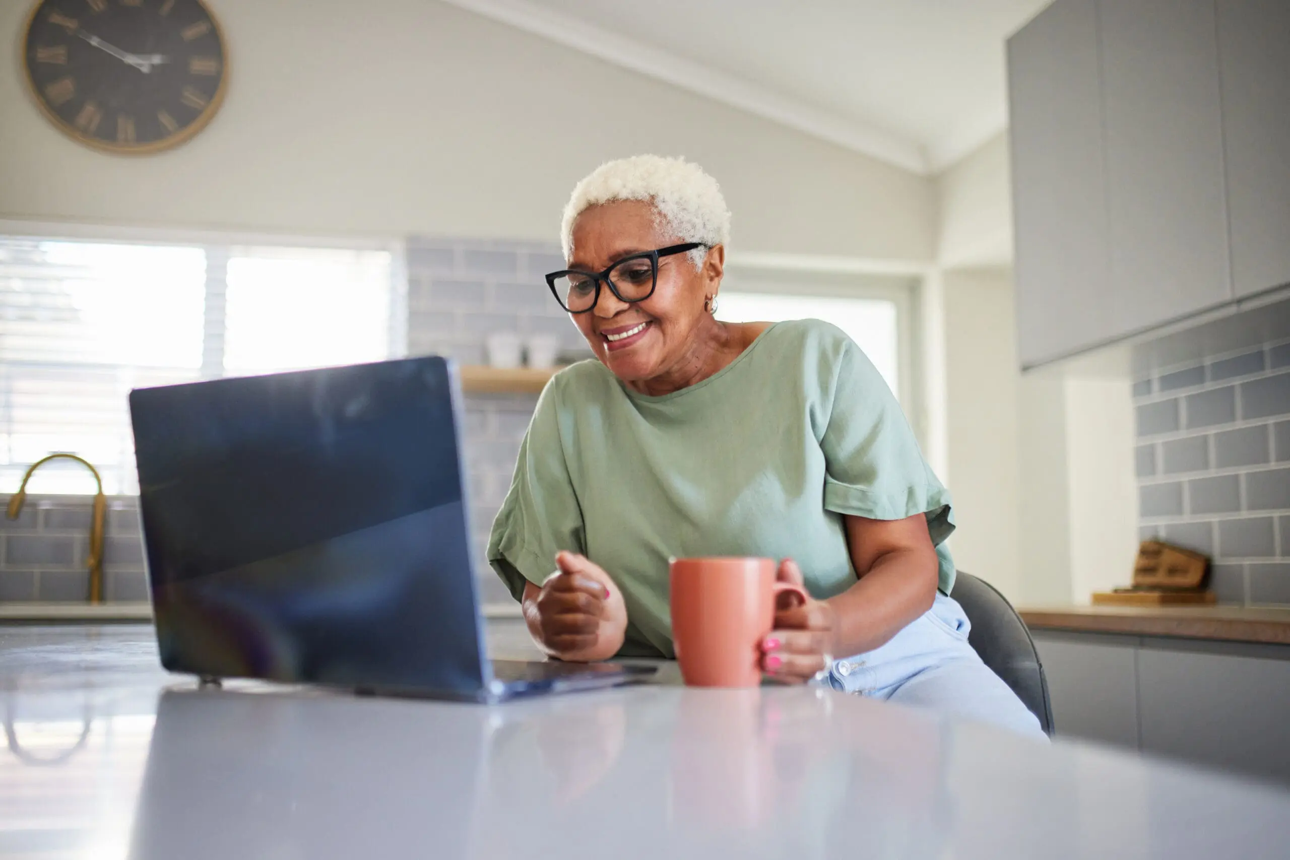 An elderly woman searching the internet for best computer for seniors.