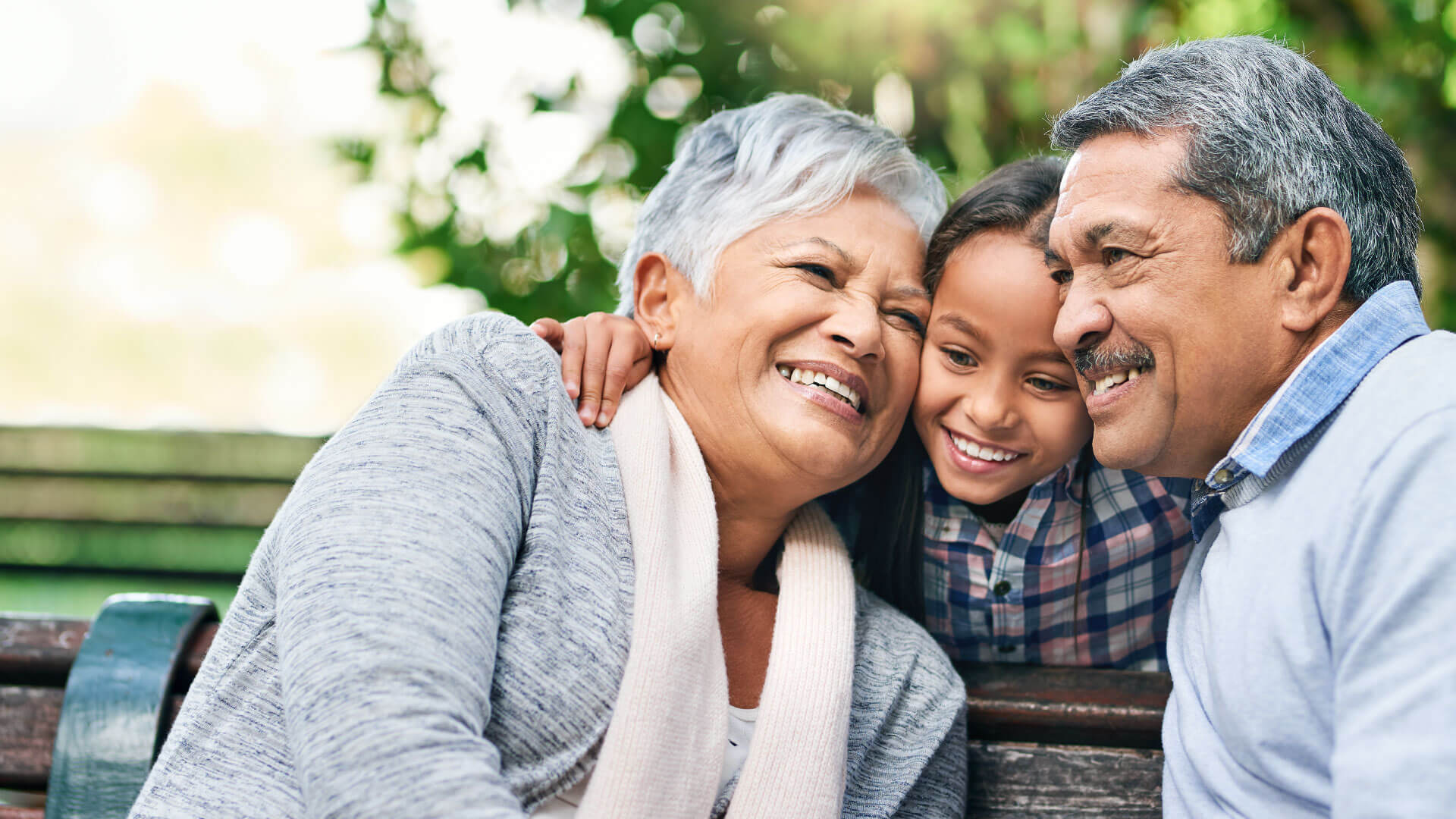 couple hugging their granddaughter