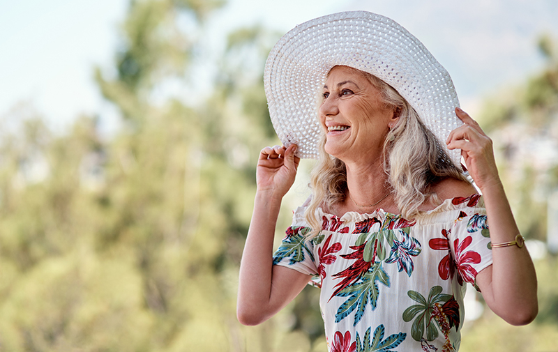 Cropped shot of an attractive senior woman smiling while standing outdoors on a summer's day