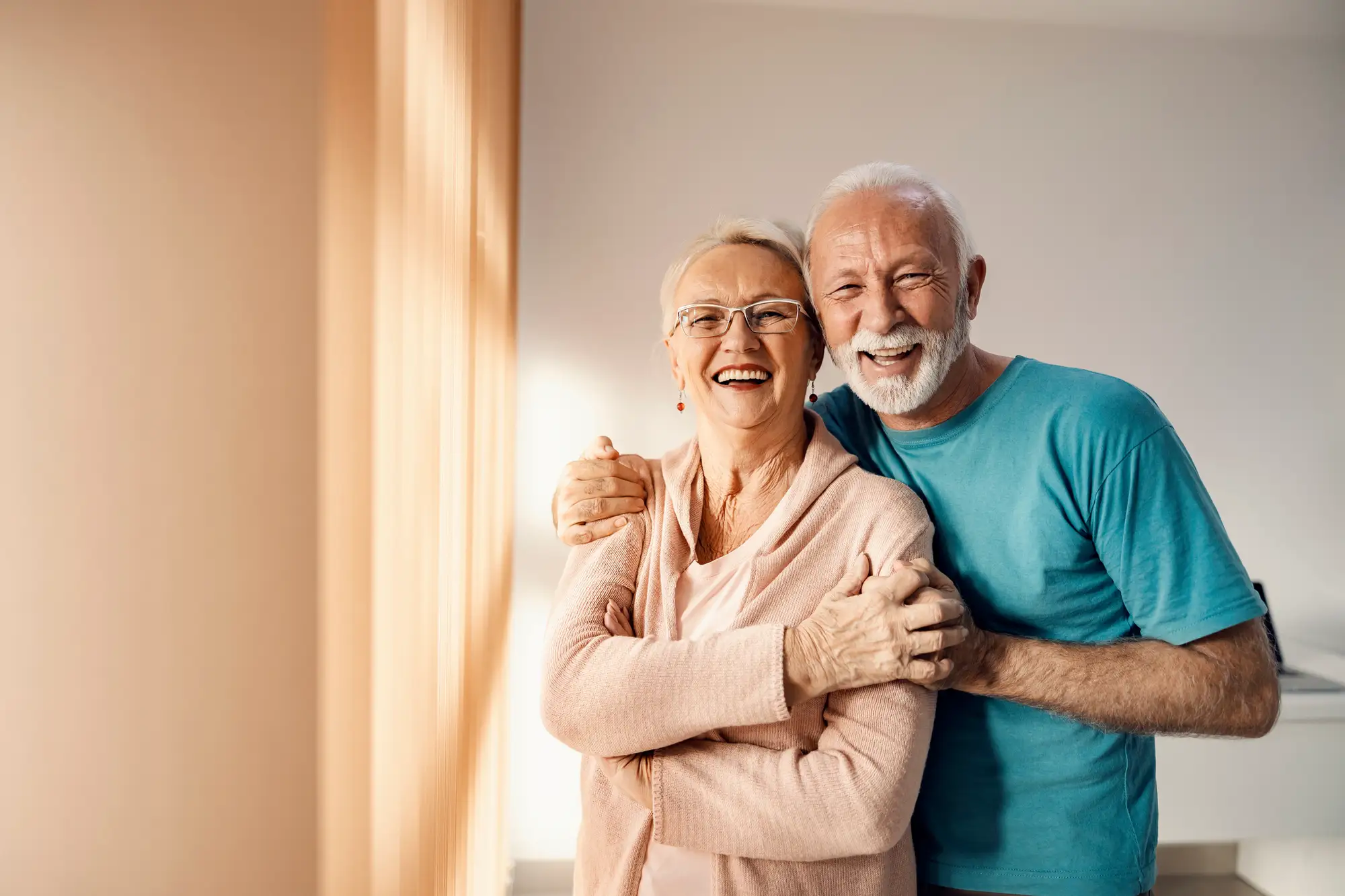 happy senior couple embracing each other from their home at Clarendale West End in Nashville, TN.