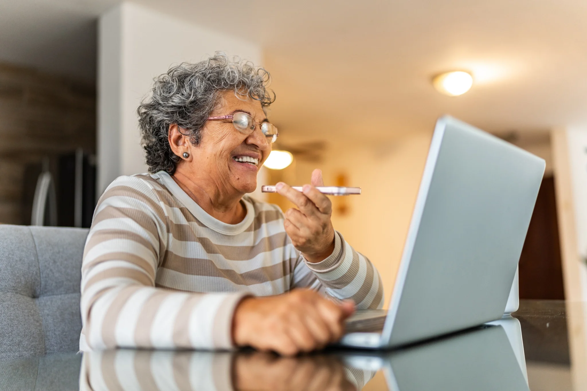 An elderly woman learning on AI for seniors on a computer at Clarendale West End in Nashville, TN.