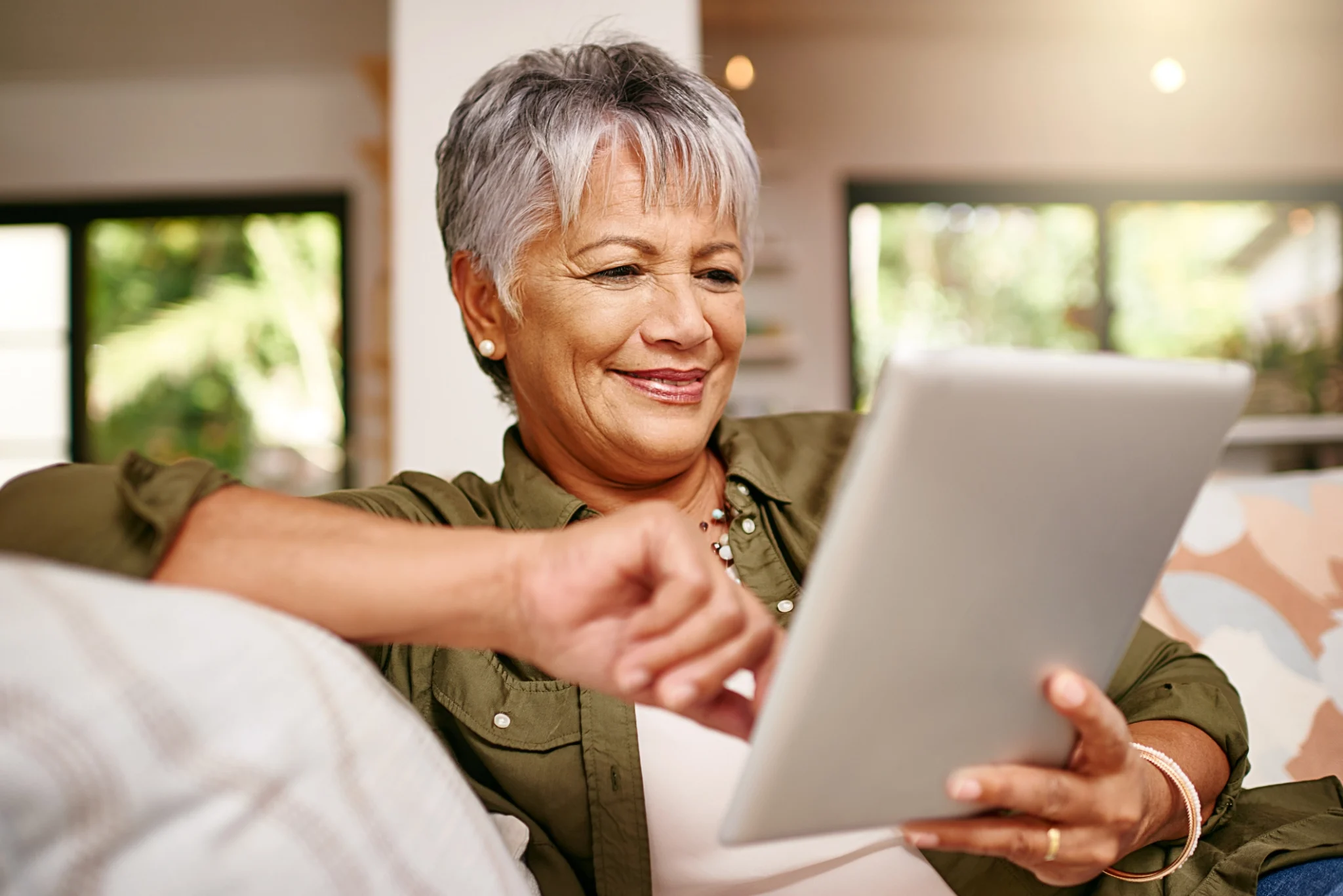 An elderly woman learning about AI chatbots on her tablets in her home at Clarendale West End in Nashville, TN.